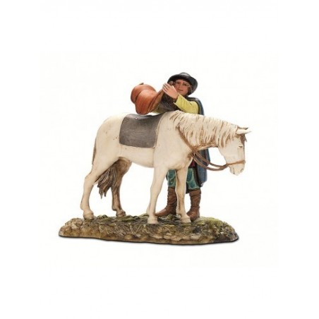 Uomo che sella cavallo