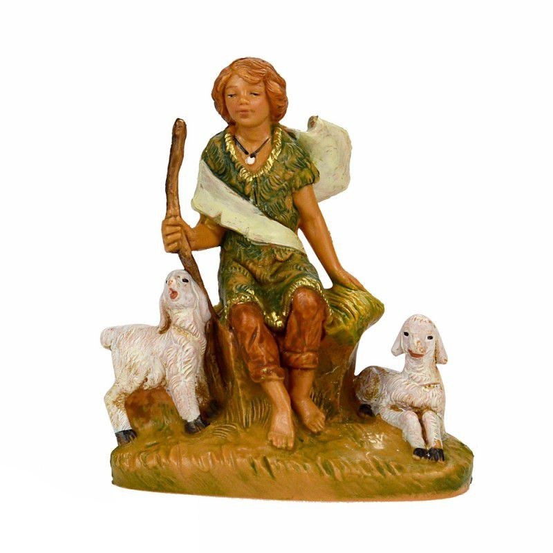 Ragazzo seduto con pecore